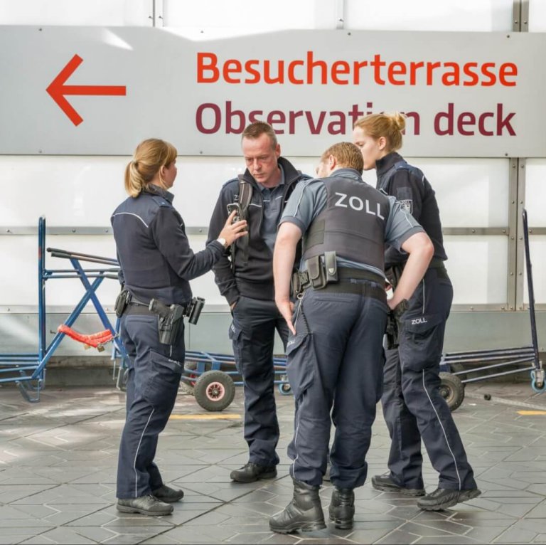 German import and export agents standing discussing customs